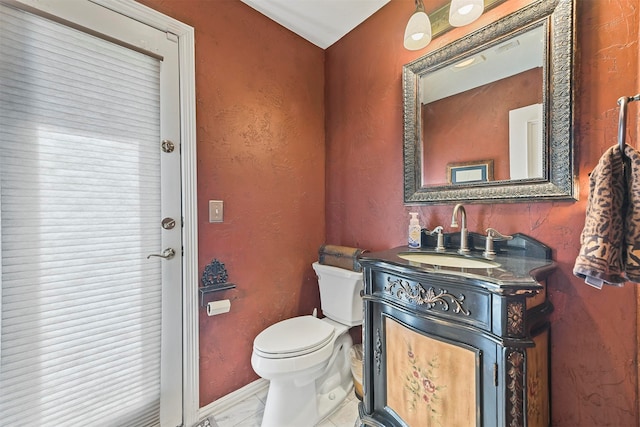 bathroom featuring tile patterned flooring, vanity, and toilet