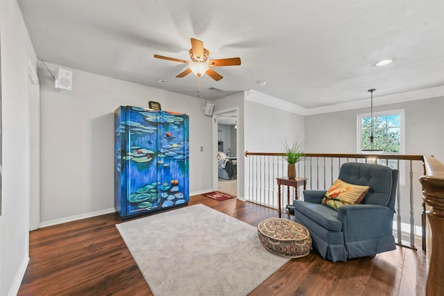 sitting room featuring ceiling fan, dark hardwood / wood-style flooring, and ornamental molding