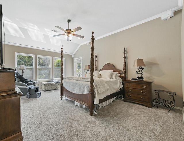 carpeted bedroom featuring ceiling fan, vaulted ceiling, and ornamental molding