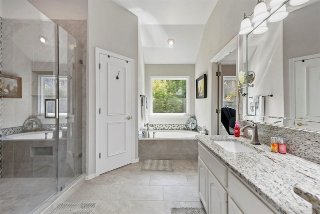 bathroom with vanity, lofted ceiling, and plus walk in shower