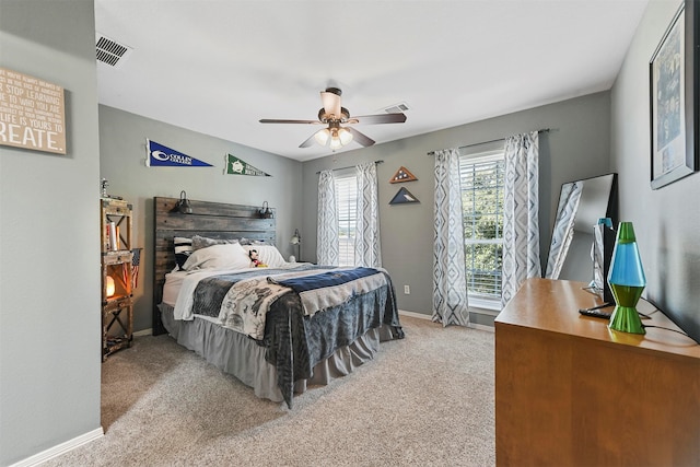 bedroom with ceiling fan and light carpet