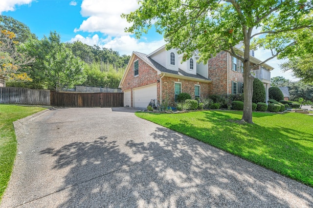 view of front of home with a garage and a front lawn