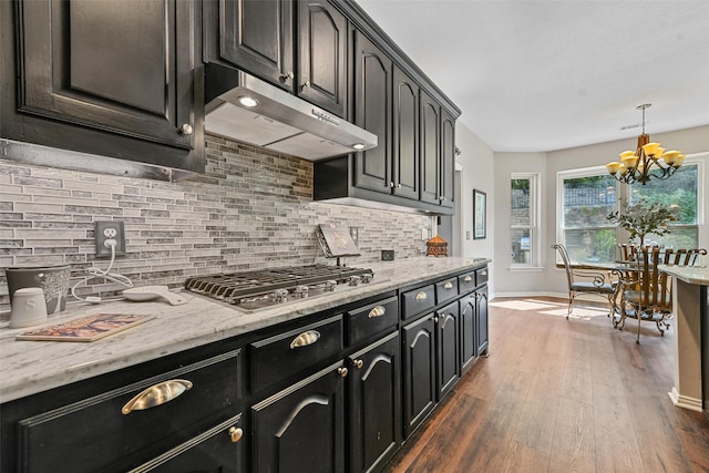 kitchen with pendant lighting, dark hardwood / wood-style flooring, tasteful backsplash, and stainless steel gas stovetop