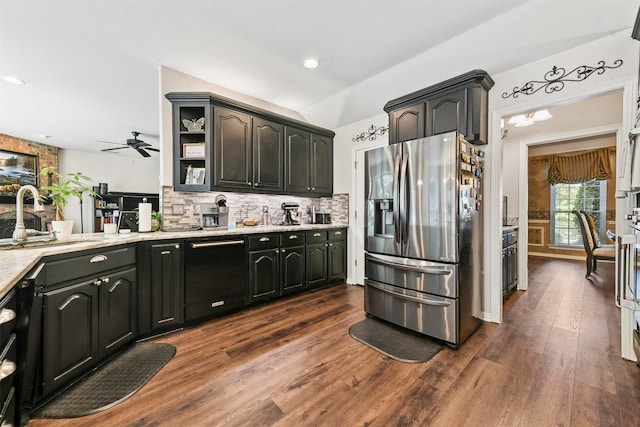 kitchen featuring ceiling fan, sink, dark hardwood / wood-style flooring, stainless steel refrigerator with ice dispenser, and decorative backsplash