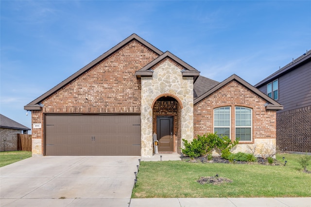 view of front of property featuring a garage and a front lawn