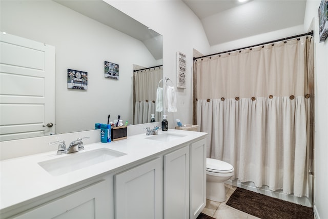 bathroom with tile patterned flooring, toilet, vanity, and lofted ceiling