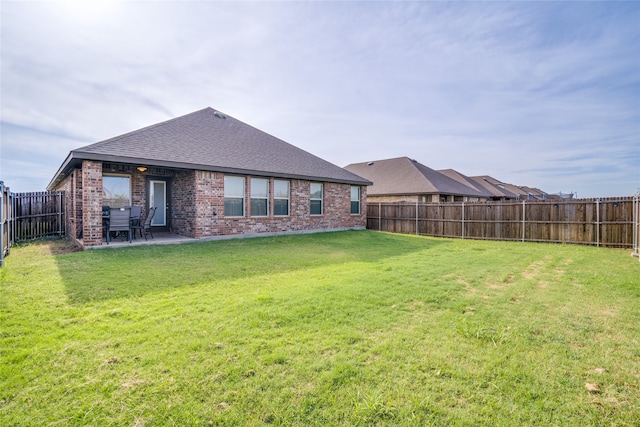 back of property featuring a patio area and a lawn