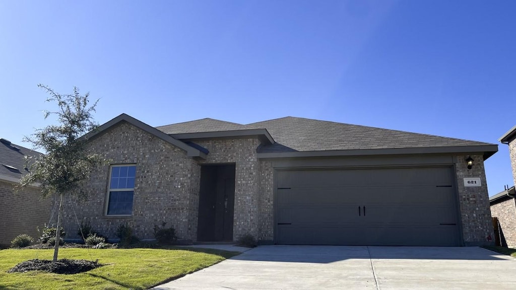 view of front of property featuring a garage and a front yard