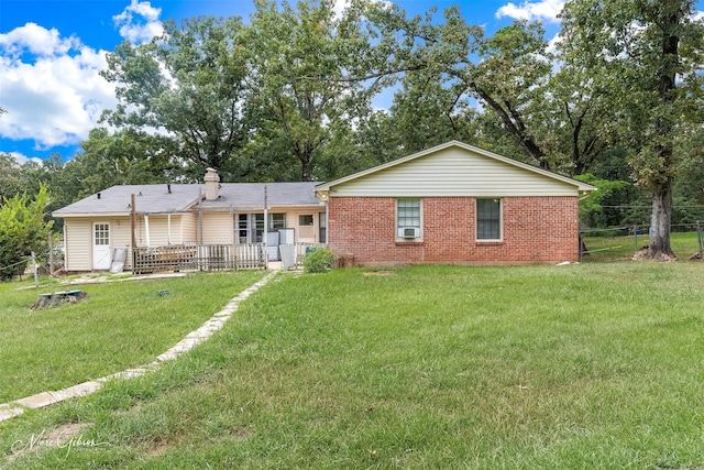 back of house with a lawn