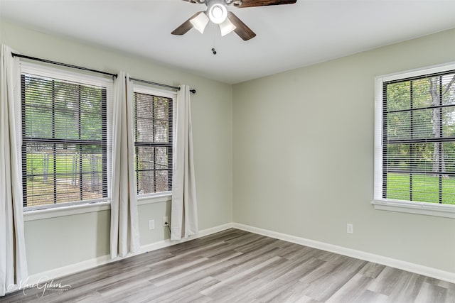 spare room featuring light wood-type flooring and ceiling fan