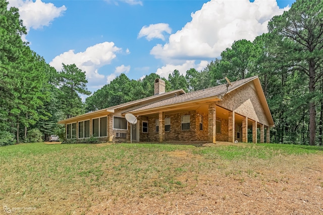 rear view of house featuring a yard