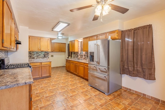 kitchen with ceiling fan, decorative backsplash, high quality fridge, gas stove, and light tile patterned flooring