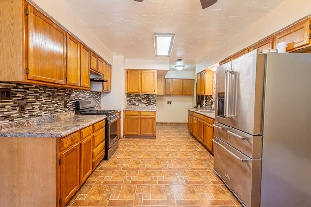 kitchen featuring light tile patterned floors, backsplash, and stainless steel appliances