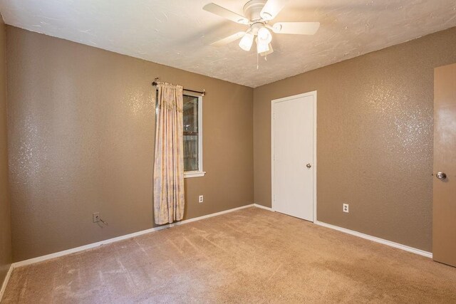 carpeted empty room with ceiling fan