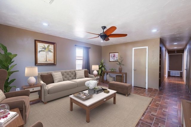 tiled living room with ceiling fan