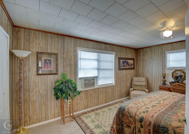 bedroom featuring wood walls, carpet, baseboards, and cooling unit