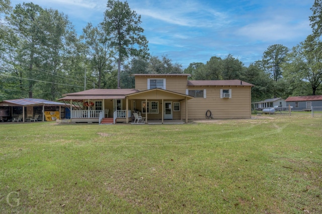 rear view of property with a porch and a yard