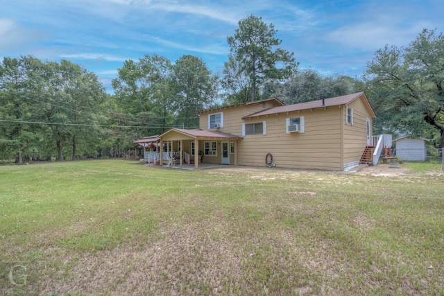 back of property with a patio and a yard