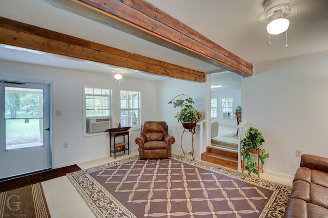 living area featuring cooling unit, beam ceiling, and baseboards