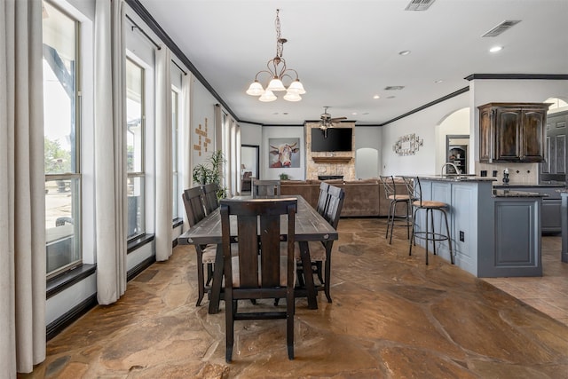 tiled dining space featuring ornamental molding and an inviting chandelier