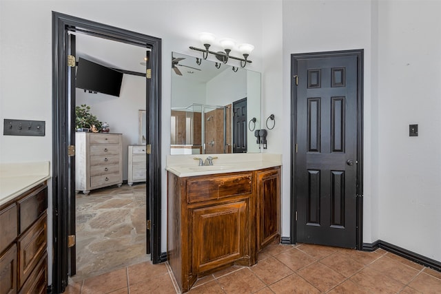 bathroom featuring vanity, a shower with shower door, and tile patterned flooring