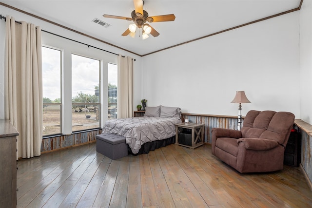 bedroom with crown molding, hardwood / wood-style floors, and ceiling fan