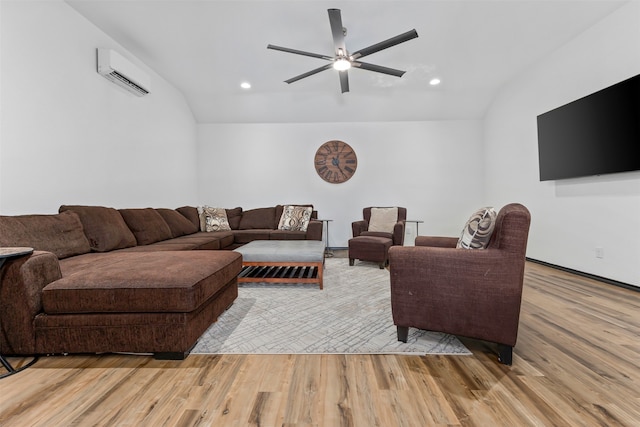 living room featuring lofted ceiling, a wall mounted AC, ceiling fan, and light hardwood / wood-style flooring