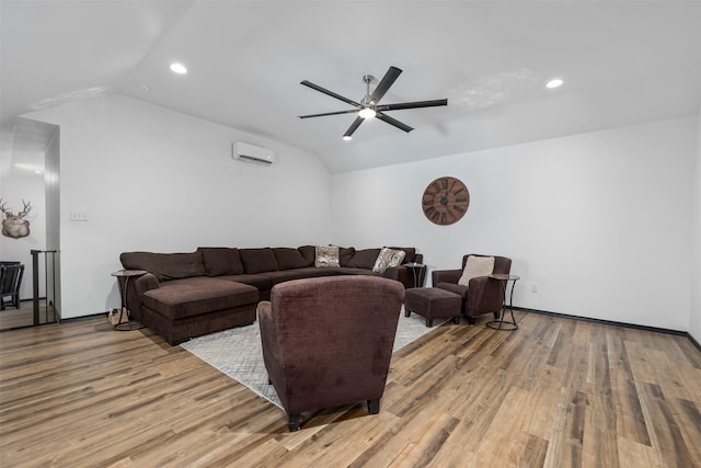 living room with lofted ceiling, a wall mounted AC, ceiling fan, and light wood-type flooring