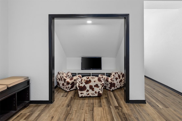 living area featuring dark hardwood / wood-style floors and vaulted ceiling