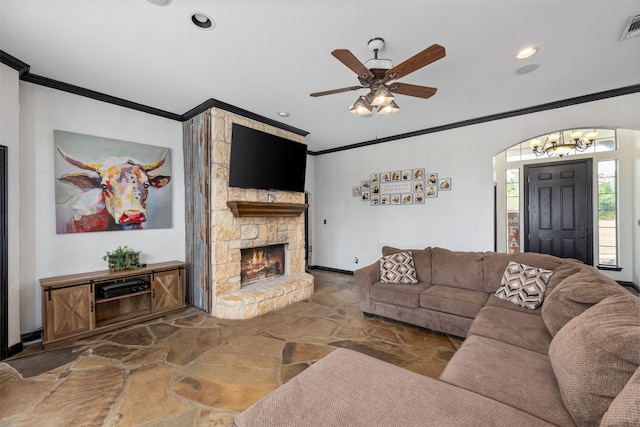 tiled living room featuring ornamental molding, ceiling fan with notable chandelier, and a fireplace