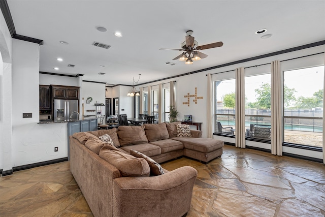 living room with ceiling fan, sink, light tile patterned flooring, and ornamental molding