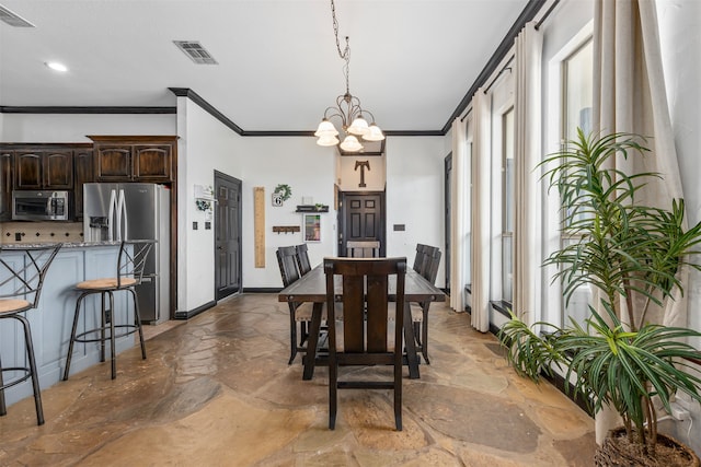 dining area with a notable chandelier and ornamental molding