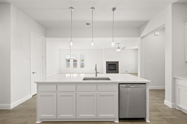 kitchen with sink, dishwasher, and white cabinetry