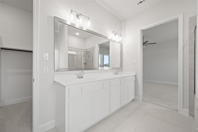 bathroom with vanity, ceiling fan, a shower with shower door, and tile patterned flooring