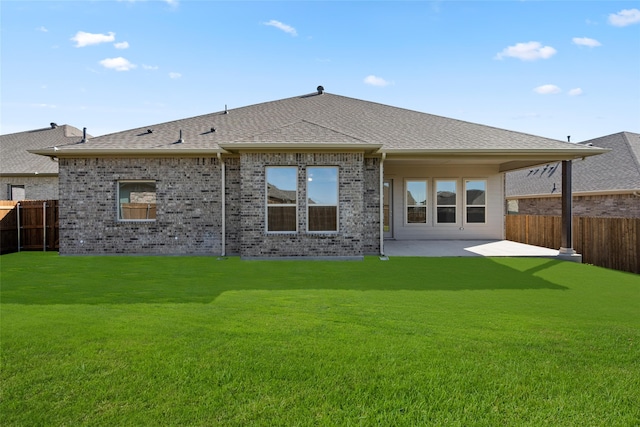 back of house featuring a yard and a patio