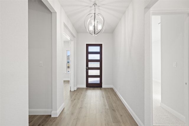 entryway featuring a notable chandelier and light wood-type flooring