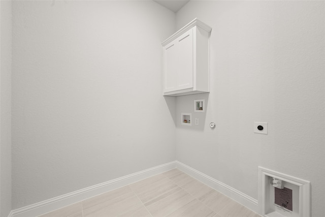 washroom featuring hookup for a gas dryer, electric dryer hookup, washer hookup, and cabinets