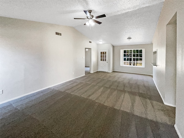 unfurnished living room with ceiling fan, carpet flooring, vaulted ceiling, and a textured ceiling