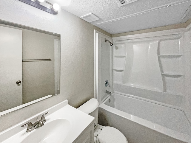 full bathroom with a textured ceiling, toilet,  shower combination, and vanity