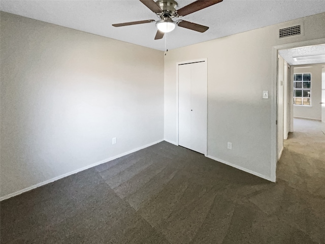 interior space with a textured ceiling and ceiling fan