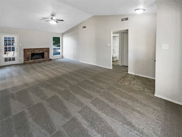 unfurnished living room with a fireplace, vaulted ceiling, a textured ceiling, carpet flooring, and ceiling fan