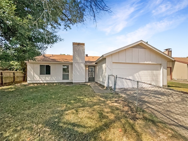 view of front of property with a garage and a front yard