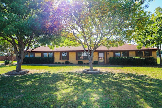 single story home with brick siding and a front lawn