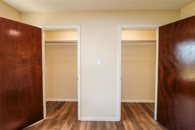 unfurnished bedroom with a closet and dark wood-type flooring