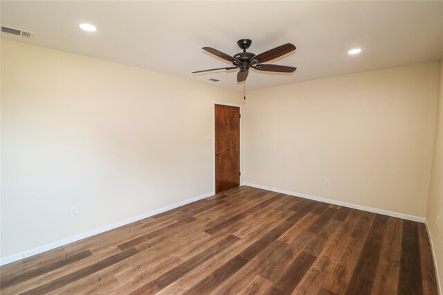 unfurnished room with dark wood-type flooring, recessed lighting, visible vents, and baseboards