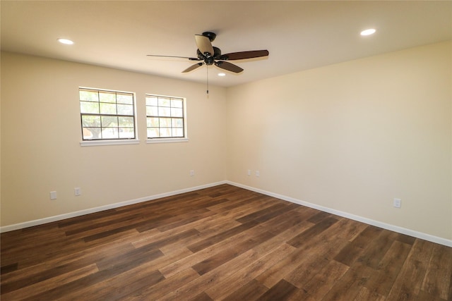 unfurnished room featuring baseboards, dark wood-style flooring, and recessed lighting