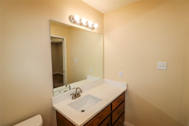 half bath featuring toilet and vanity