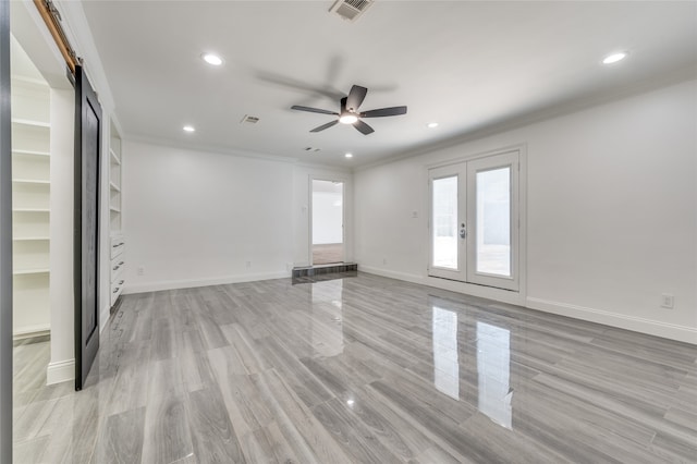 unfurnished room with ornamental molding, ceiling fan, french doors, and light wood-type flooring