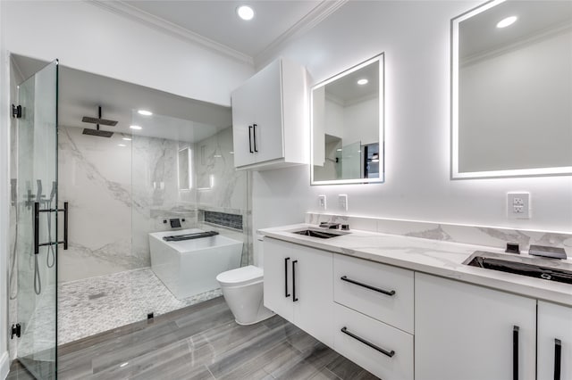 bathroom featuring a shower with shower door, toilet, crown molding, and vanity