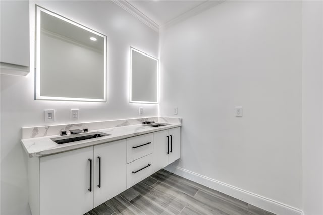 bathroom featuring hardwood / wood-style flooring, crown molding, and vanity